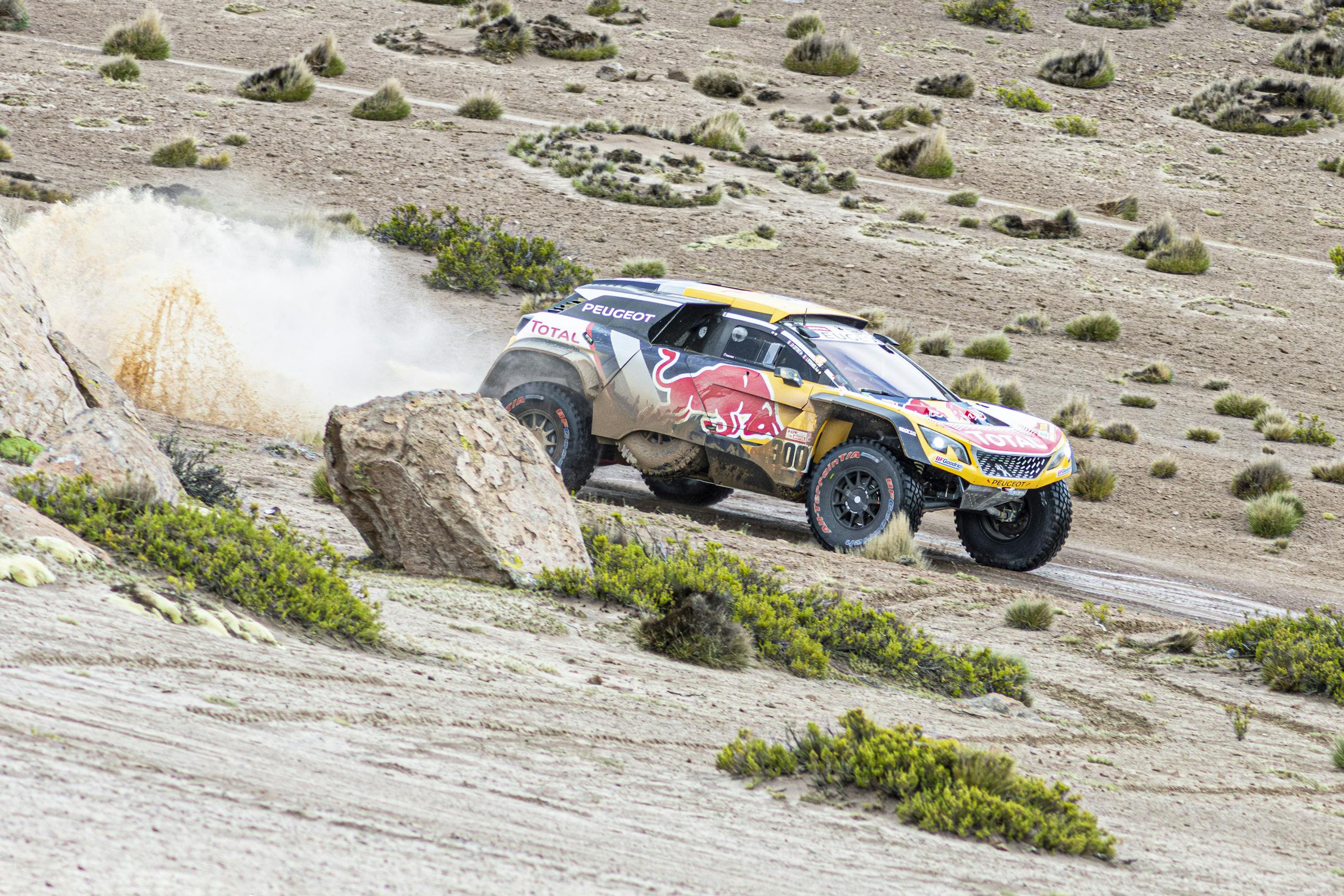Dynamic off-road race car kicking up dust in the desert near Arequipa, Peru.